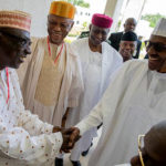 President Muhammadu Buhari (right) shakes Chairman, PDP National Caretaker Committee, Ahmed Makarfi, behind is APC National Chairman, John Odigie Oyegun.