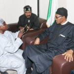 Senior Special Assistant to the president on media and publicity, Garba Shehu (kneeling) and Nigerian President Muhammadu Buhari