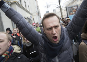 Russian opposition leader Alexei Navalny, centre, shouts slogans as he attends a rally in Moscow, Russia, Sunday, Jan 28, 2018. PHOTO: AP.