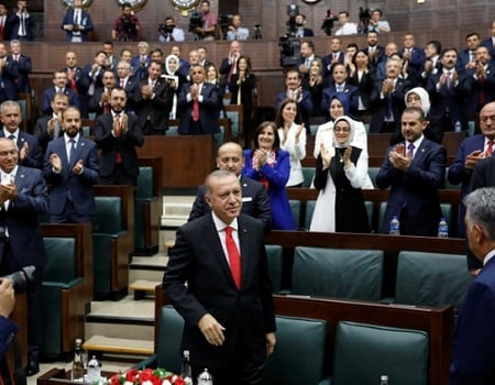 Turkish President Tayyip Erdogan greets members of parliament from his ruling AK Party (AKP) as he arrives at the Turkish parliament in Ankara, Turkey, July 7, 2018.