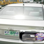 The Uber car that the man took to the Third Mainland Bridge and his belongings (INSET) in the booth of the car. Photos: Sylvester Okoruwa, NAN