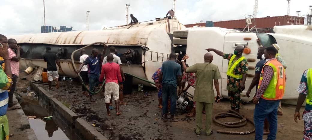 tanker, scooping petrol from fallen tankers