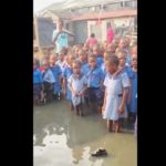 flooded school assembly ground, pupils in flooded ground