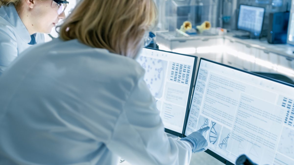 Senior Female Scientist Discusses Scientific Data with Her Labor