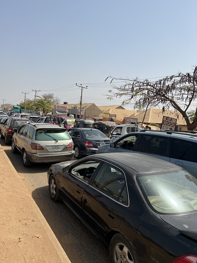 Abuja motorists hustle for PMS, Fuel scarcity: Parts of FCT on lockdown as queues ground vehicular movements