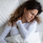 Saliva on my pillows Above view frown woman feels pain in neck