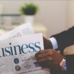 Man holding newspaper on business trading