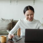 lady using the internet and taking notes