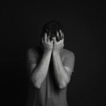 Man in the dark covering his face because of premature ejaculation