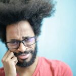 Man with dental problems wincing in pain