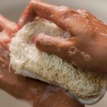 person washing the hands when bathing