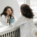 self-love, a woman looking happily at herself in the mirror