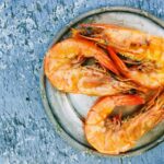 reasons your body reacts after eating shrimp, shrimps served on a plate