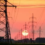 silhouette of electric post during sunset