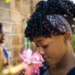 young girl smelling a fresh flower