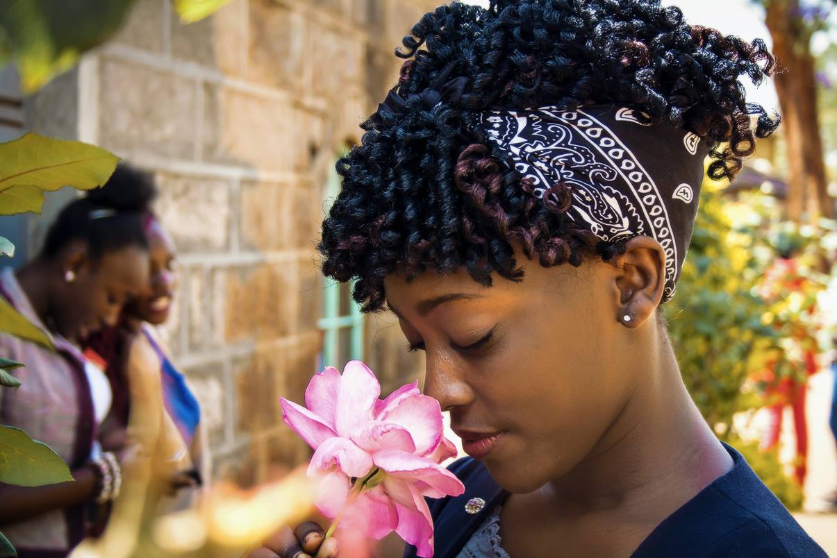 young girl smelling a fresh flower