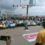 Protesters observe jumat service