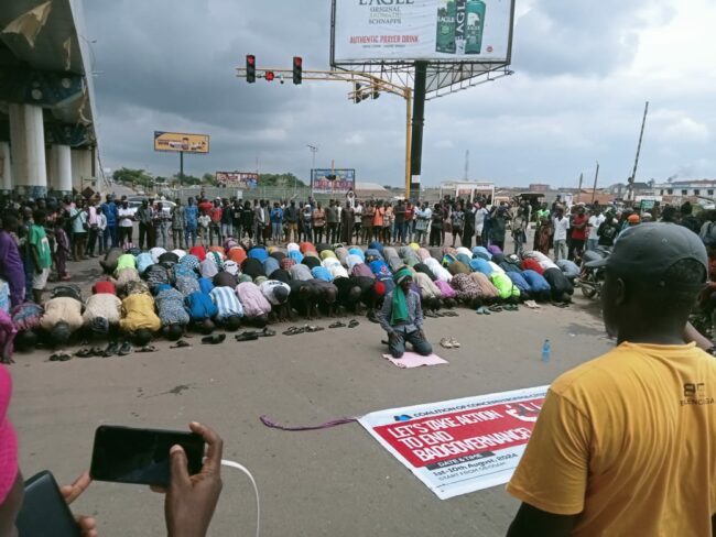 Protesters observe jumat service