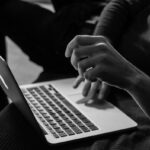 hands completing online surveys on a laptop