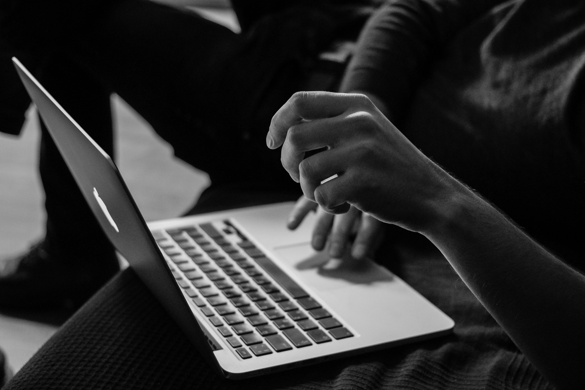 hands completing online surveys on a laptop