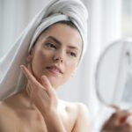 woman using essential skincare products