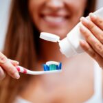 Brushing the tooth twice daily
