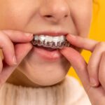 young lady using dental braces