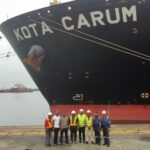Officials of Onne Multipurpose Terminal (OMT) and Nigerian Ports Authority (NPA) in front of MV Kota Carum — the largest vessel ever to call at Onne Port - berthing at the Onne Multipurpose Terminal (OMT), Onne, Rivers State, recently
