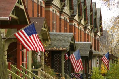 Picture of building in the United States with the US flag in front.