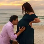 a pregnant woman wearing a stylish outfit