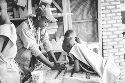 A man teaching young boys in the workshop