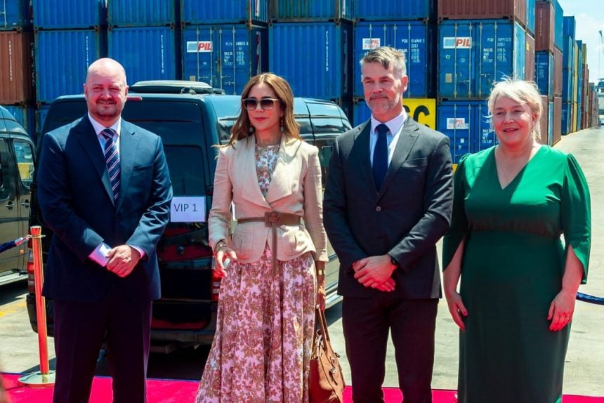 Queen of Denmark standing with her entourage