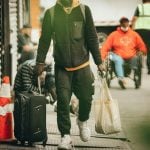 a man travelling with travel luggage
