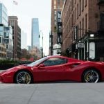 a red Ferrari parked by the road. Ferraris are among the top most valuable cars