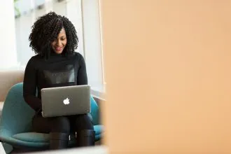 a student using an app on her apple laptop