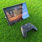 a tablet and a game pad on the grass