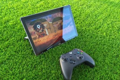 a tablet and a game pad on the grass