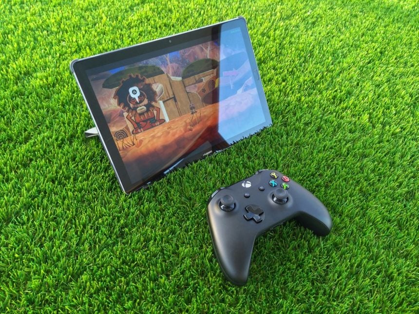 a tablet and a game pad on the grass