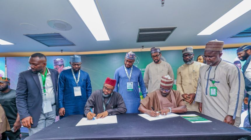 Zamfara State governor, Dauda Lawal and REA Managing Director, Abba Abubakar Aliyu signing the MoU on solar energy,