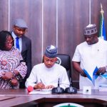 Governor Ahmed Ododo signing a bill,