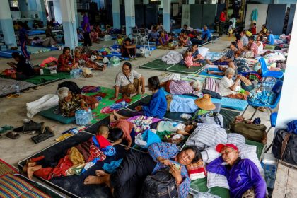 People rest at a shelter, following recent clashes along the disputed border between Thailand and Cambodia