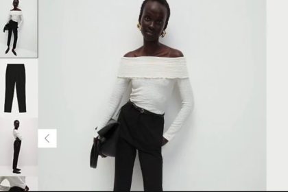 a skinny model standing and carrying a black bag