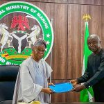 The Honourable Minister of Marine and Blue Economy, His Excellency Adegboyega Oyetola, CON (left) receiving a presentation from the Acting President, Fisheries Cooperative Federation of Nigeria (FCFN), Mr. Mashi Gabriel Sani, at an interactive session with fisheries cooperatives groups in Abuja on Wednesday.