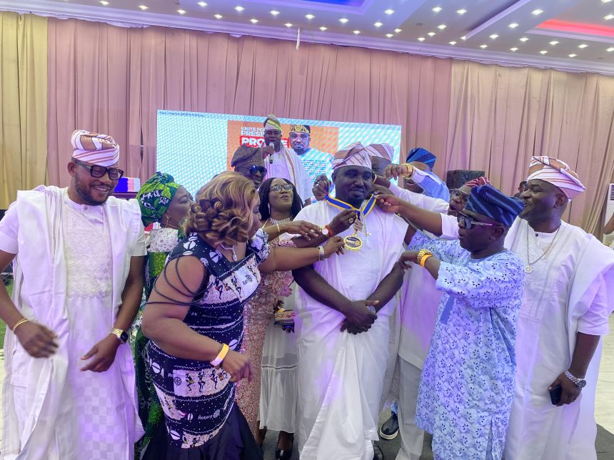Newly-installed President of the Rotary Club of Ibadan Gold, Mr Kazeem Aidi (centre) being decorated by the past presidents on Saturday.
