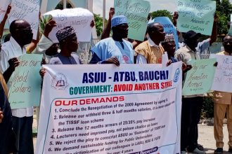 Members of the Academic Staff Union of Universities (ASUU), Abubakar Tafaea Balewa University (ATBU), protesting with a banner