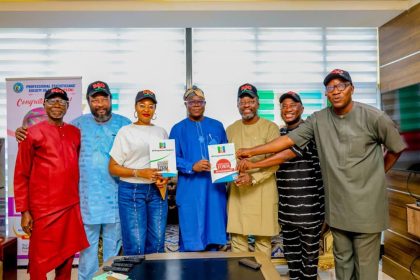 EKSU alumni posed with the APC National Secretary, Ajibola Basiru and the nomination forms purchased for Governor Biodun Oyebanji