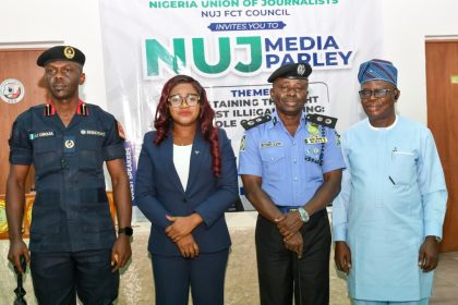 Nigeria Union of Journalists (NUJ) FCT Council members with FCT Commissioner of Police standing at a media parley on illegal mining in Nigeria