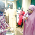 Niger State Commissioner of Transport, Hajiya Hadiza Idris Kuta presenting gifts to victims at Munya Local Government Area