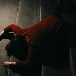 Woman lying down on stairwell