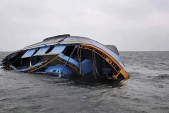 An overturned boat floating in the water,